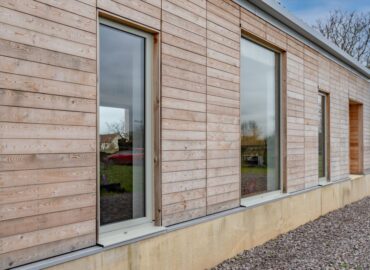 pebble grey doors next to wooden cladding.