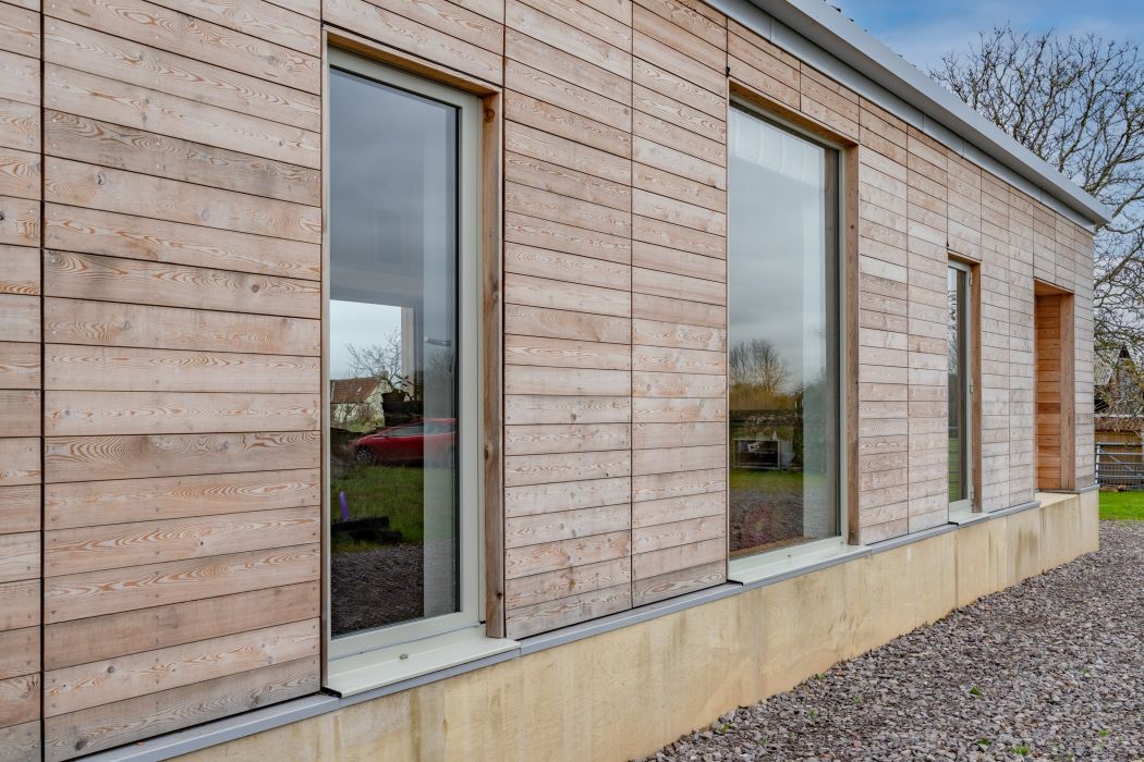 pebble grey doors next to wooden cladding.